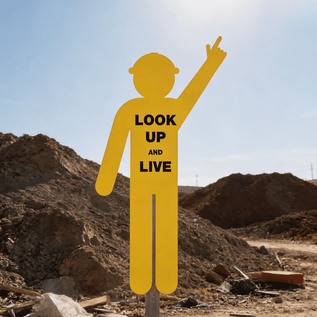 Yellow Cutout Safety Construction Worker (Pointing Up, Look Up and Live) Sign